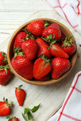 Concept of tasty eating with fresh strawberry on wooden table