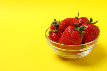 Fresh tasty strawberry on yellow background, space for text
