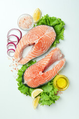 Fresh raw salmon and ingredients for cooking on white background