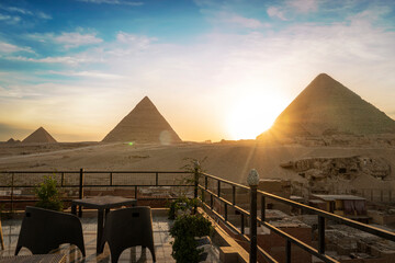Great Pyramids of Chephren Khafra and Cheops Khufu and Mikerina Menkaura. Sunset on Giza plateau....