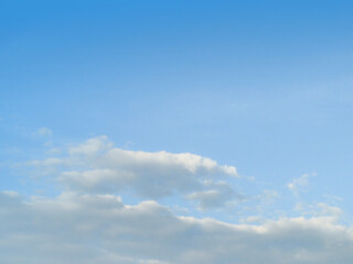 White fluffy clouds in the blue sky background. The image in clearing day and good weather on morning of the summer season.