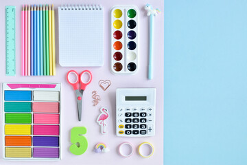 Background with stationery in pastel colors on a light blue background, space for text. Office...