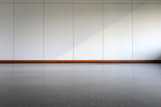 Empty room interior with black floor and white wall background. Free space for display or montage products.