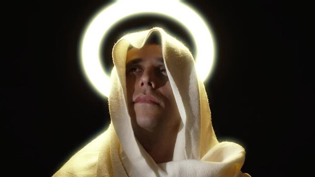 Holy man in a cape with a halo above his head