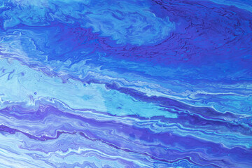 Blue-purple waves of paint. Abstract background with marble effect
