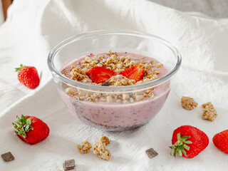 Chia strawberry pudding and coconut milk in a glass bowl. Healthy breakfast. Vegan recipe