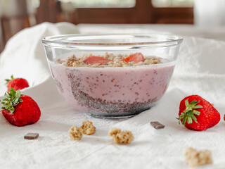 Chia strawberry pudding and coconut milk in a glass bowl. Healthy breakfast. Vegan recipe