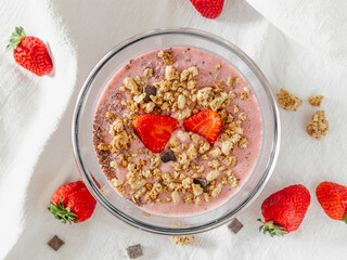 Chia strawberry pudding and coconut milk in a glass bowl. Healthy breakfast. Vegan recipe. Top view