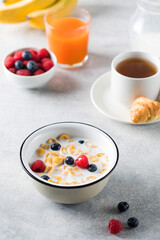 Cornflakes with berries and milk. Dry breakfast.