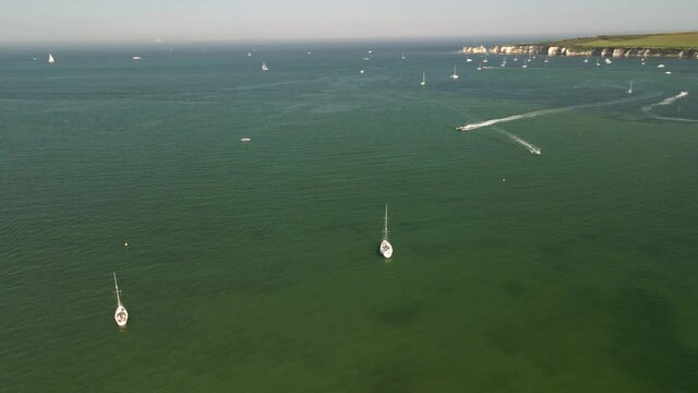 Sailing heaven aerial seaside view with yachts and boats on clean water, summer holiday, Studland, England