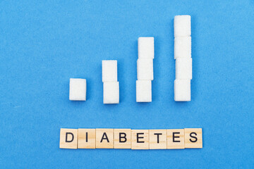 growing, increasing sugar columns, graph and word diabetes on blue background