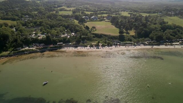 Aerial view of people on summer holiday on Sandy Beach Swanage Studland England 4K