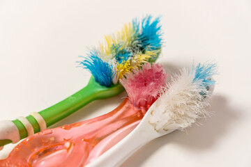 Old, spoiled, disheveled, colored toothbrushes renewal, replacement