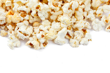 Heap of delicious popcorn, isolated on white background. Scattered popcorn texture background. Close-up.