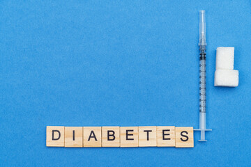 sugar, syringe and word diabetes on blue background
