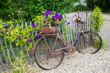 old vintage bicycle with basket on a wooden fence