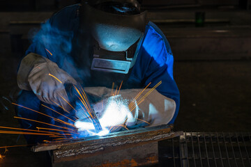 A male worker chia steel in an industrial factory. Concept industry.
