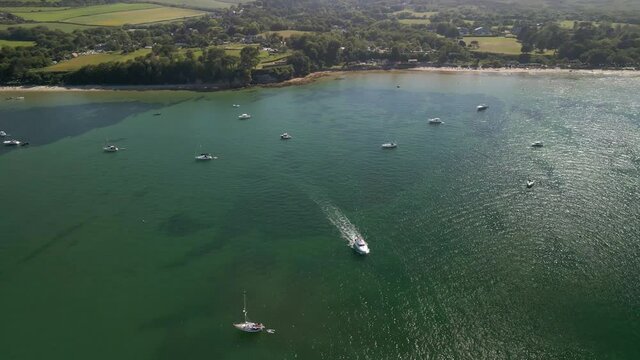 Flying over expensive boats and yachts Studland seaside coast and beach summer holiday