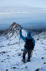 A hiker with a backpack climbing the Pico de Orizaba