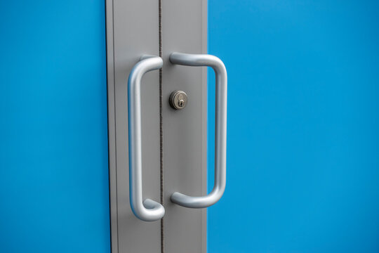 Silver Door Handles Outside Of A Business Building, With A Blue Screen Effect