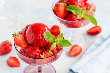 Strawberry sorbet with mint and fresh berries in glass bowls. Fruit berry  summer ice cream. Vegetarian healthy dessert. Selective focus 