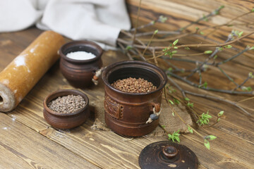 Raw cereals in rustick bowls on wooden background