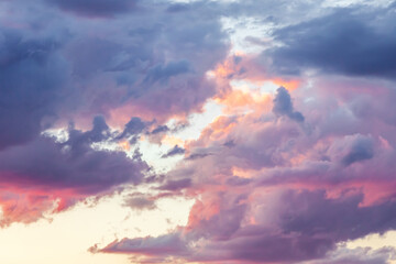 Naklejka na ściany i meble Dark clouds lit by the setting sun