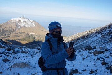 Fototapeta na wymiar Hiker taking a selfie during on the Pico de Orizaba