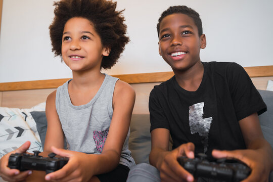 Two brothers playing video games at home.