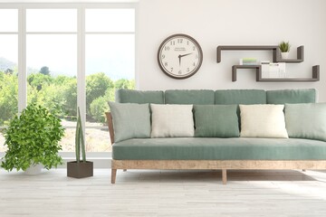 Naklejka premium White living room with sofa and summer landscape in window. Scandinavian interior design. 3D illustration