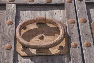 Rusty iron ornaments and trim on old wooden doors on the outside