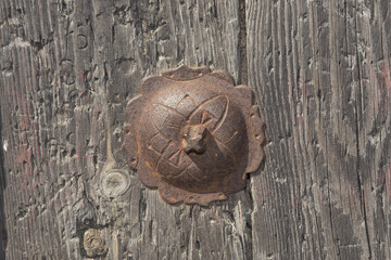 Rusty iron ornaments and trim on old wooden doors on the outside