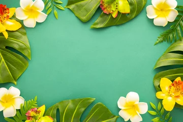 Fotobehang Summer background with tropical orchid flowers and green tropical palm leaves on green background. Flat lay, top view. Summer party backdrop © Svetlana Kolpakova