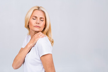 Senior mature woman with shoulder pain, isolated on white background.