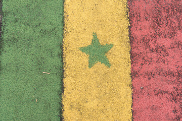 Flag of Cameroon painted on asphalt in the country's colors. Alphast texture and paint colors.