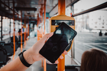 woman hand Paying conctactless with smartphone in public transport