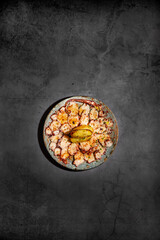 Flat lay food photography of sliced octopus beautiful decorated. Top view of modern version of a modern cuisine of a typical spanish tapas meal with copyspace.
