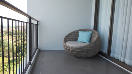 Outdoor beach chair on the hotel room balcony or terrace which made from natural wood called rattan...