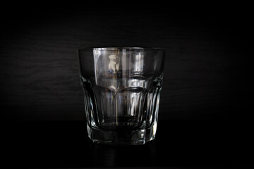 Empty spirits glass on black