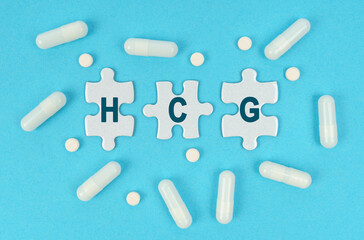 On a blue background, there are pills and puzzles with the inscription - HCG