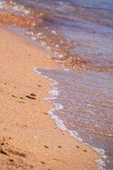Soft wave of the sea on the sandy beach.