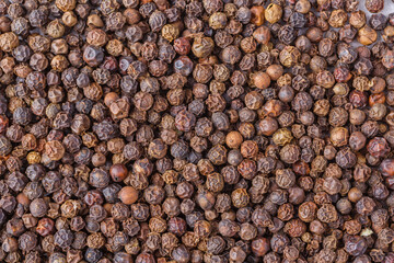 Large pile of allspice peas. Food background.Background made of middle eastern traditional spice . Top view.Textures of colorful spices and condiments.