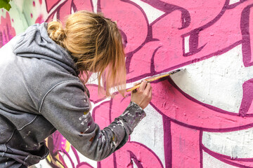 Female Artist doing artificial typography graffiti