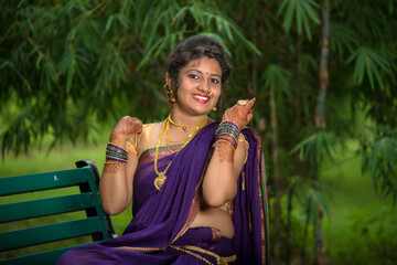 Indian Traditional Beautiful young girl in saree posing outdoors