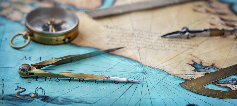 Poster an old geographic map with navigational tools: compass, divider, ruler, protractor. view of the work