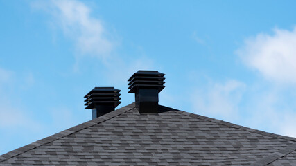 Ventilation covers on a new house shingle roof