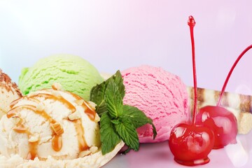 Scoops of different ice creams and ingredients on a background