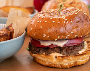grilled burger and plate with fried potatoes 