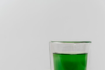 Healthy drink liquid chlorophyll extract with cup of water on white background