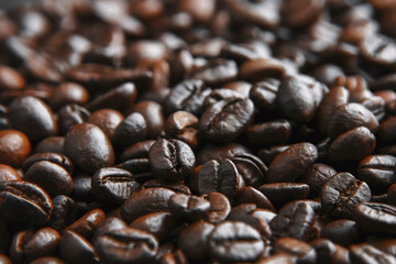Coffee beans background. Brown roasted coffee beans. Closeup shot of coffee beans.  Fresh roasted coffee beans.